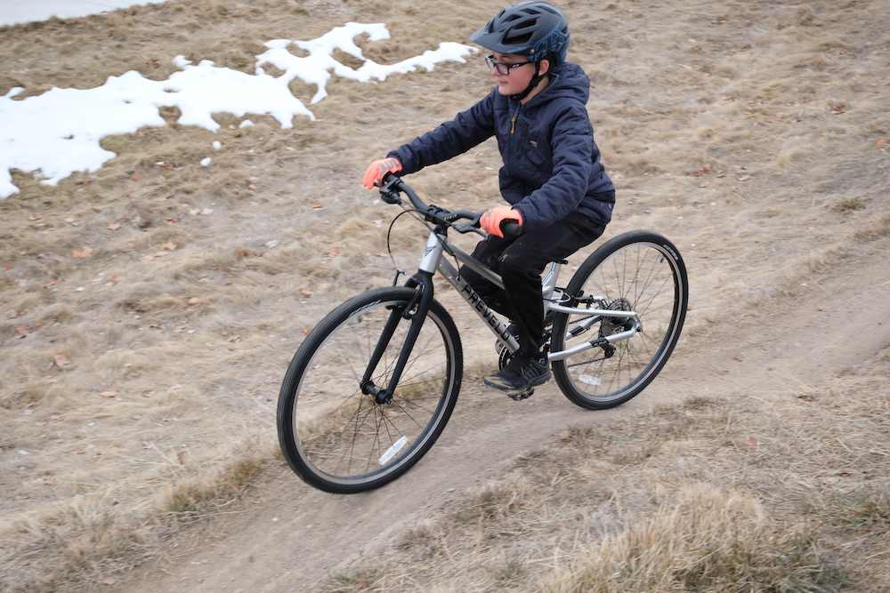 Prevelo Alpha Five ridden on a compact dirt trail