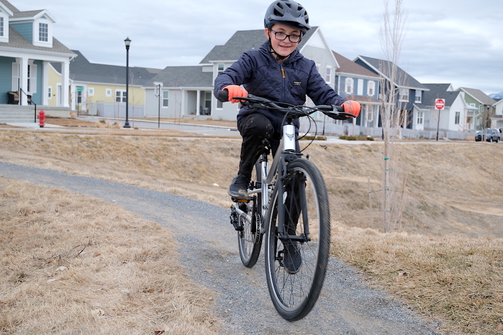 child riding the prevelo alpha five on a gravel trail