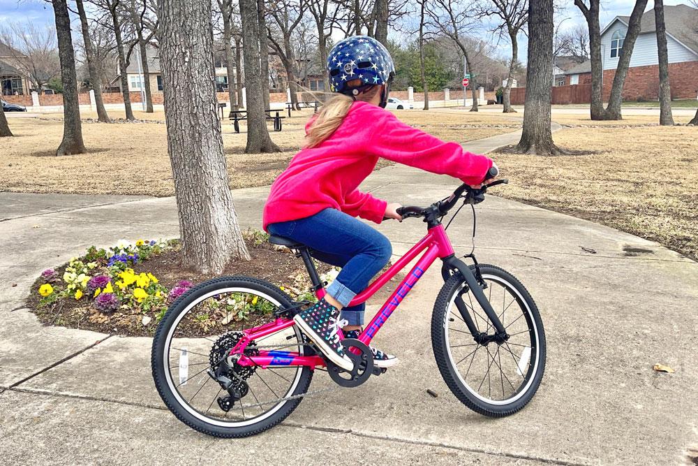 Child riding Prevelo Alpha Three on tight path in park