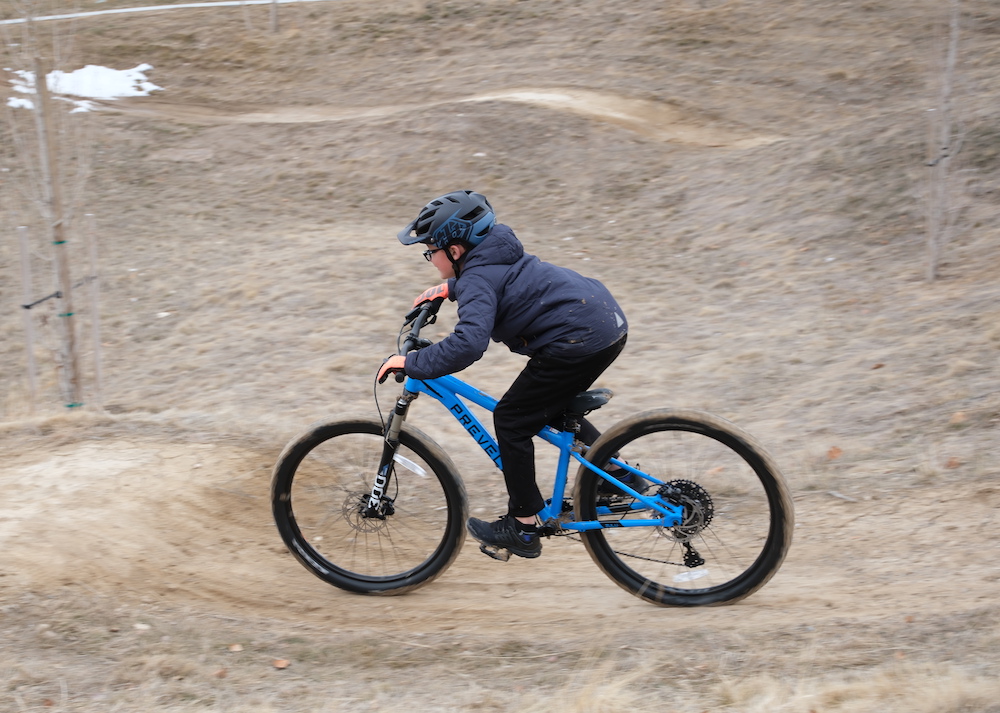 child riding the Prevelo Zulu Five 26" kids mountain bike