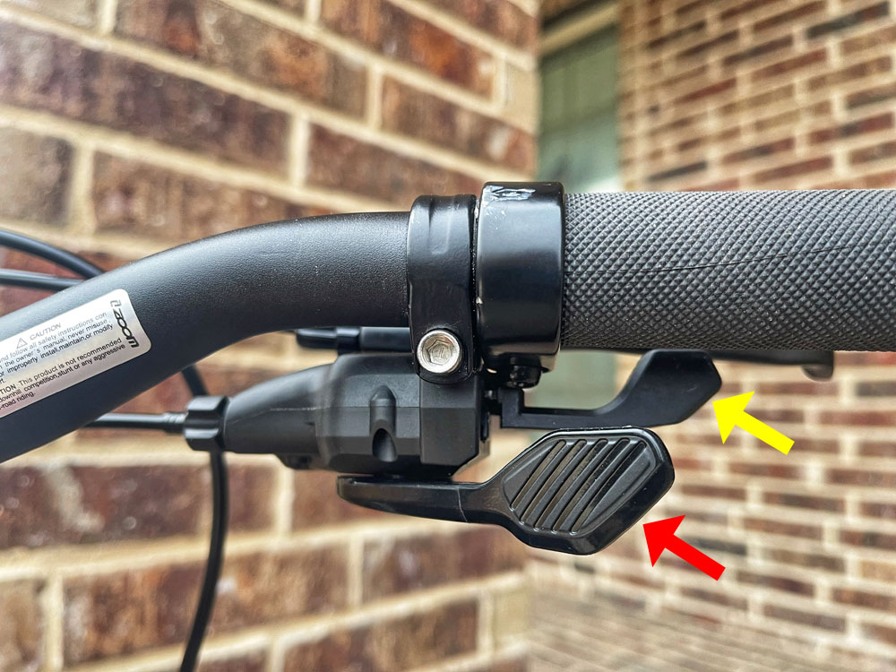 Thumb and forefinger trigger shifter buttons on Prevelo 20" bike