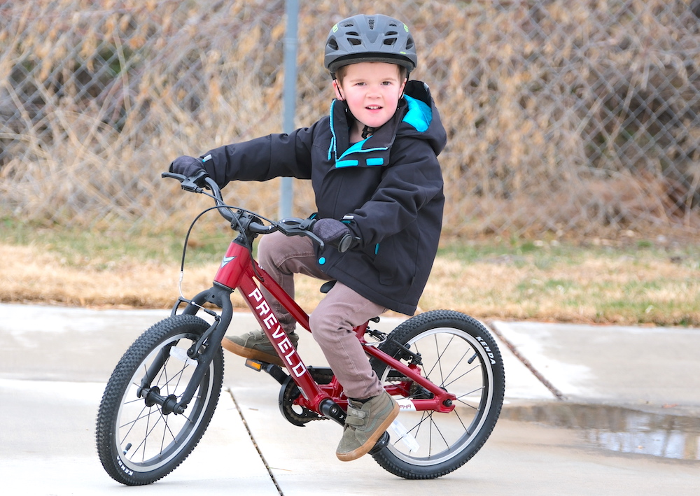 4 year old riding Prevelo Alpha Two bike in red
