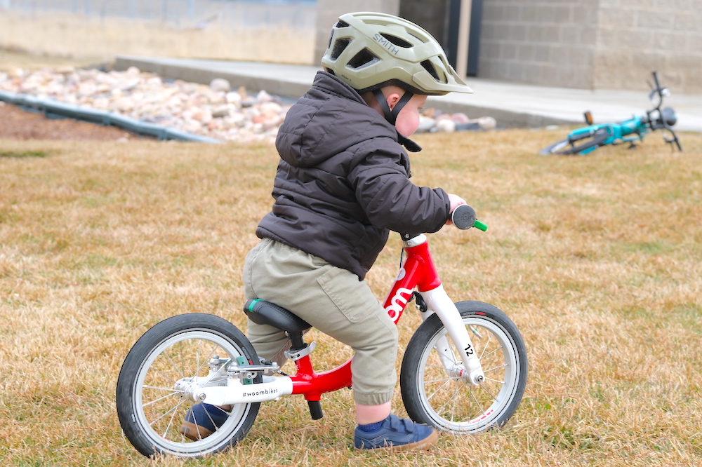 18 month old running through grass on his woom 1 balance bike