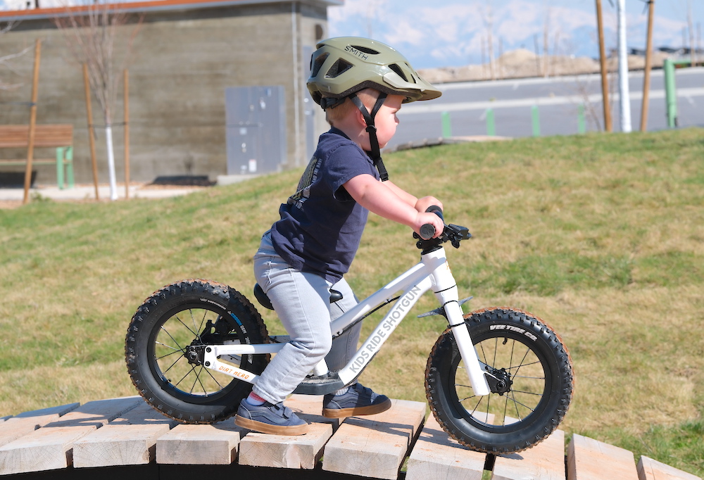 toddler riding the DIrt Hero balance bike with the 12" wheel kit