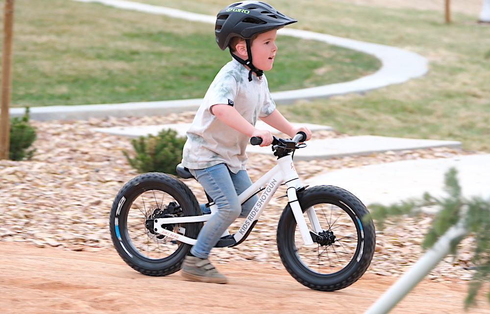 young boy riding the Dirt Hero off-road balance bike