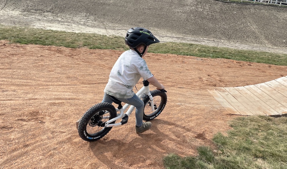 boy taking a turn at speed on his Dirt Hero balance bike