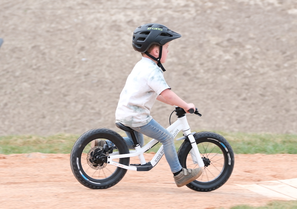 boy looking forward while running on his Dirt Hero balance bike