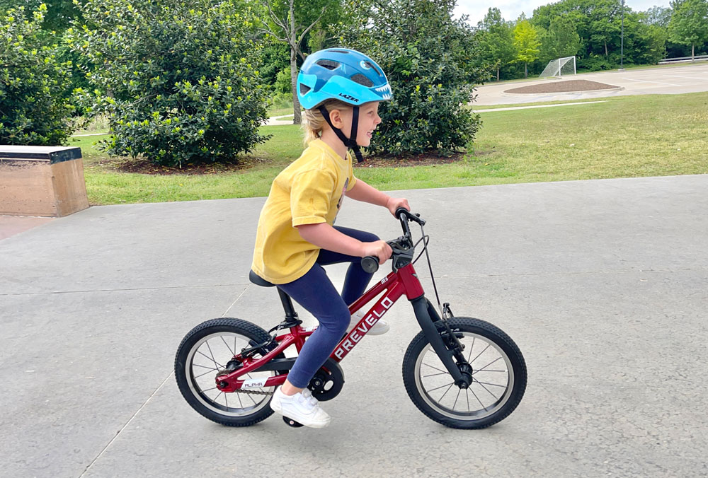 3-year-old riding 2023 Prevelo Alpha One in red at the skatepark
