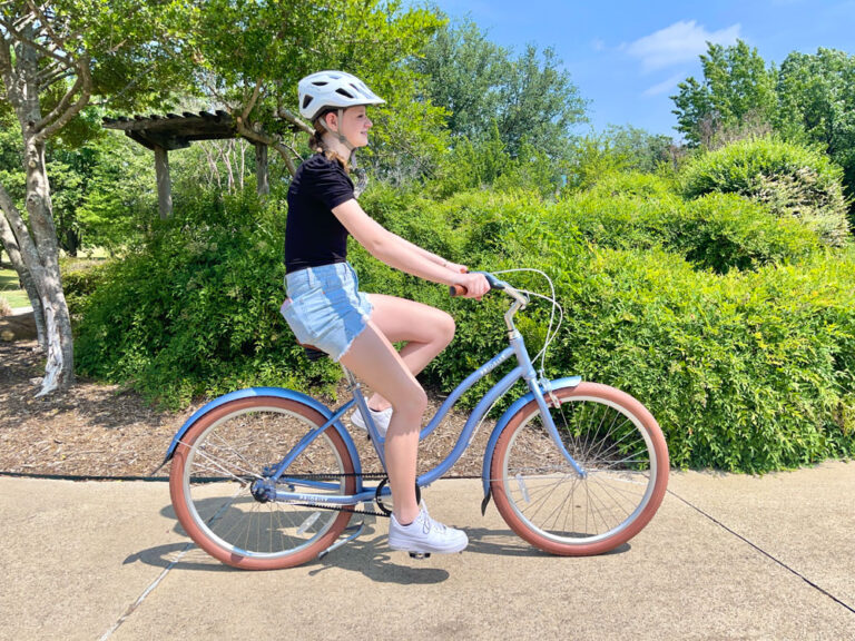 Young woman riding Priority Coast on sidewalk