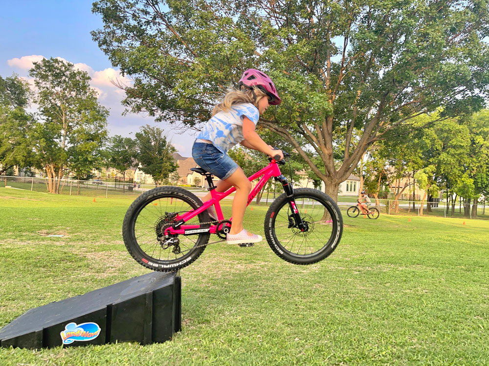 5 year old jumping off ramp on the Trailcraft Blue Sky 20