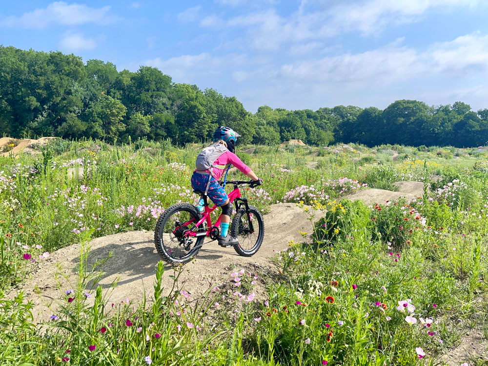 5 year old girl riding down jump line on Trailcraft Blue Sky 20