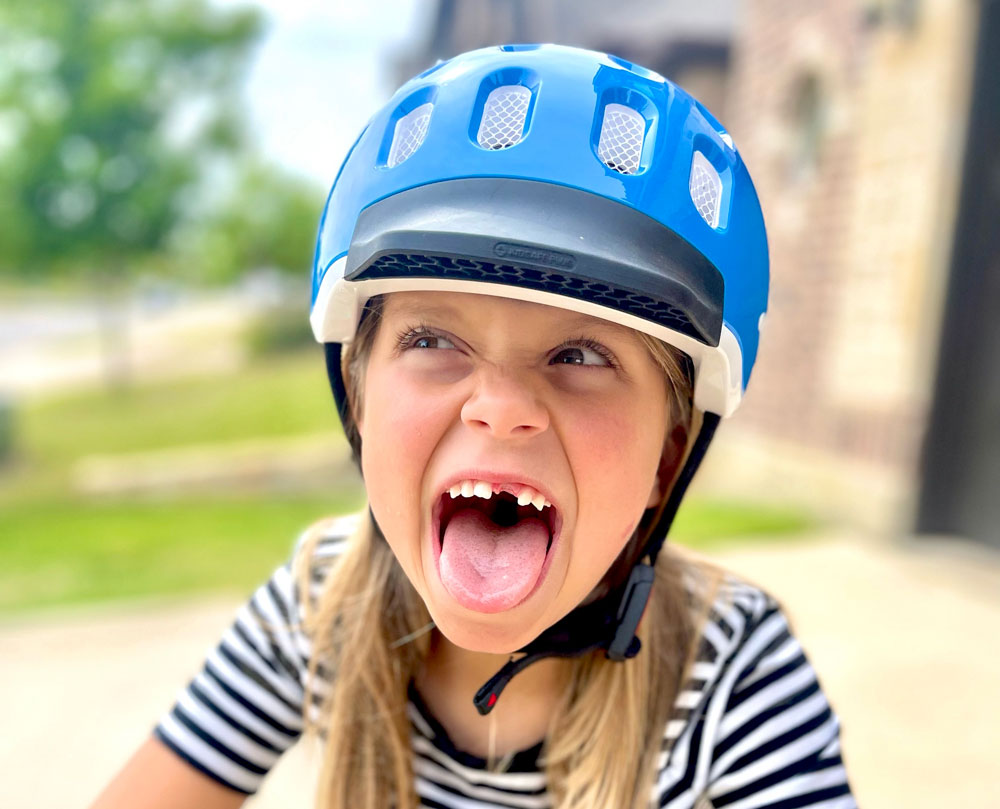 5 year old wearing woom KIDS bike helmet