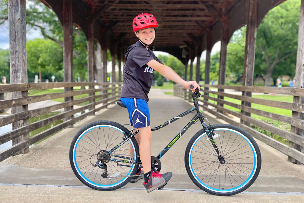 12 year old sitting on Guardian Bikes 26 on a bridget