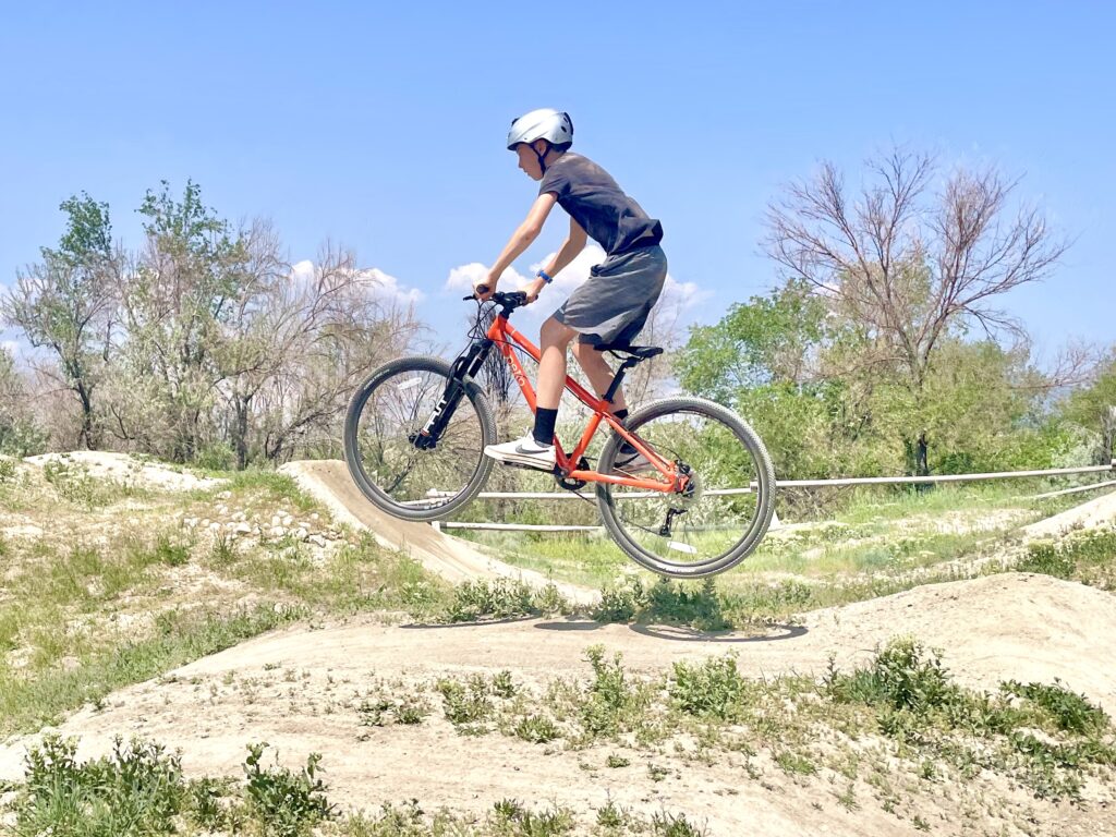 Boy jumping the Pello Roovi at the bike park