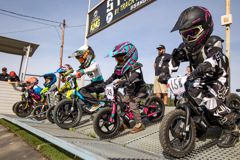 young riders lined up for a stacyc electric balance bike race