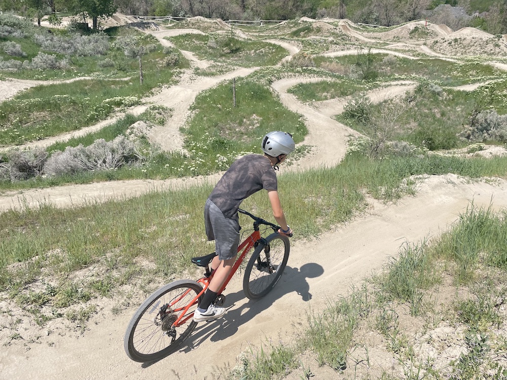 boy riding the pello roovi kids bike at a bike park