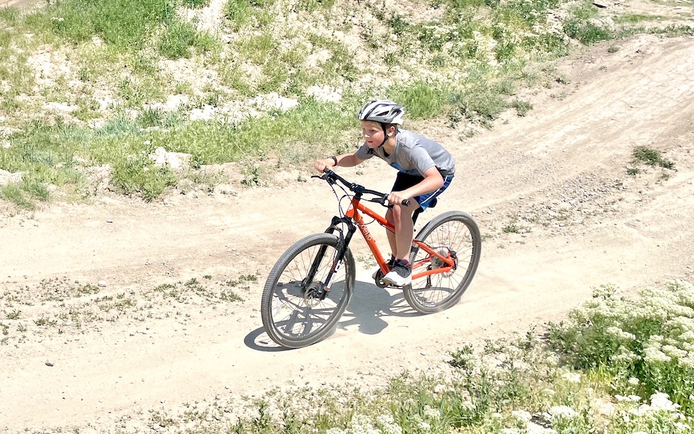 boy riding the Pello Roovi on the a dirt trail