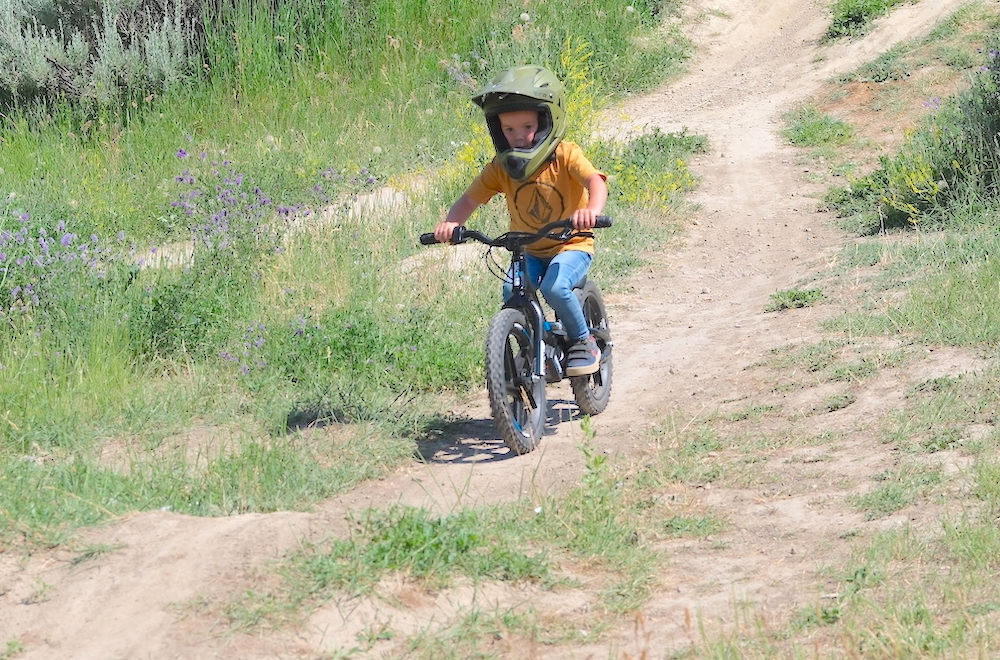 5 year old riding down a hill on his electric balance bike
