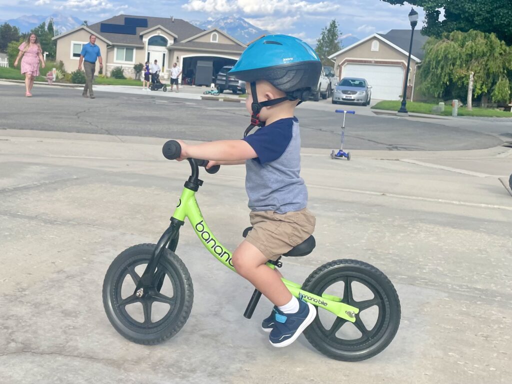 Boy lifting up feet while gliding on a balance bike