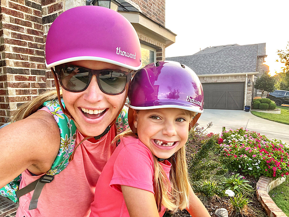 Mom and daughter in matching Thousand bike helmets