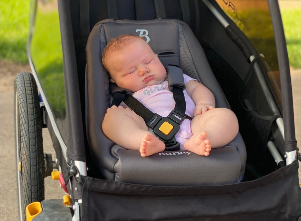 3 month old sleeping i Burley Baby Snuggler in the Burley D'Lite X