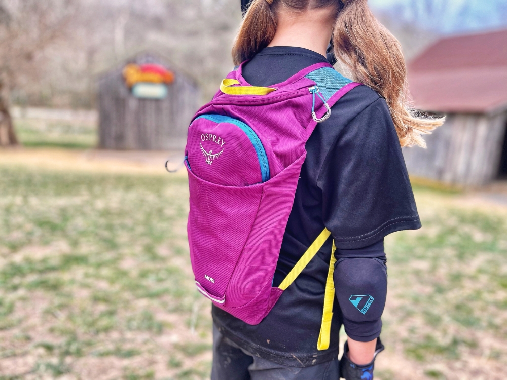6 year old wearing Osprey Moki 2023 version in purple