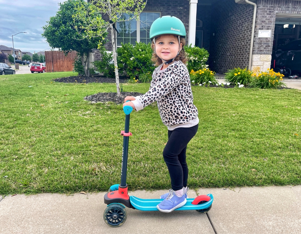 2 year old riding 3-wheel Chillafish Scottie scooter