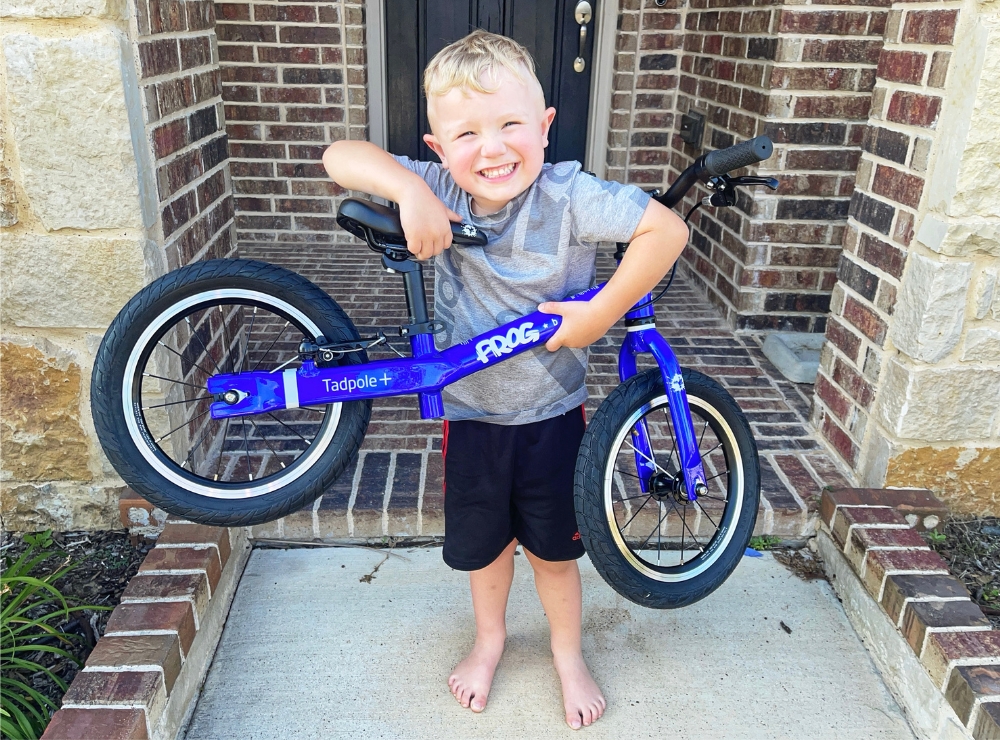 3 year old boy picking up the Frog Tadpole Plus