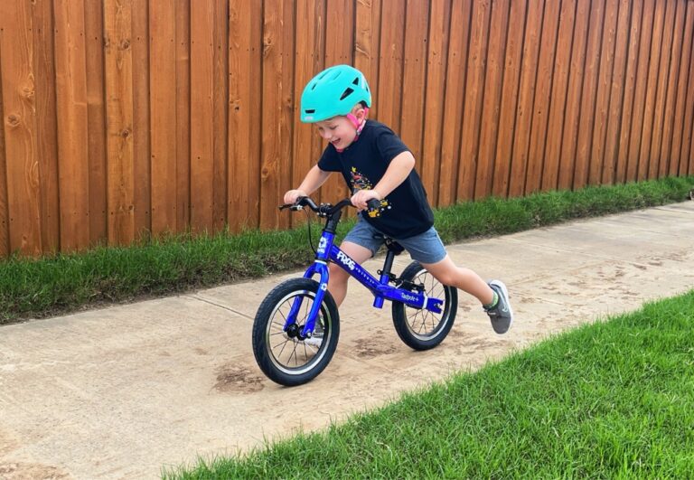 3 year old boy running down sidewalk on Frog Tadpole Plus