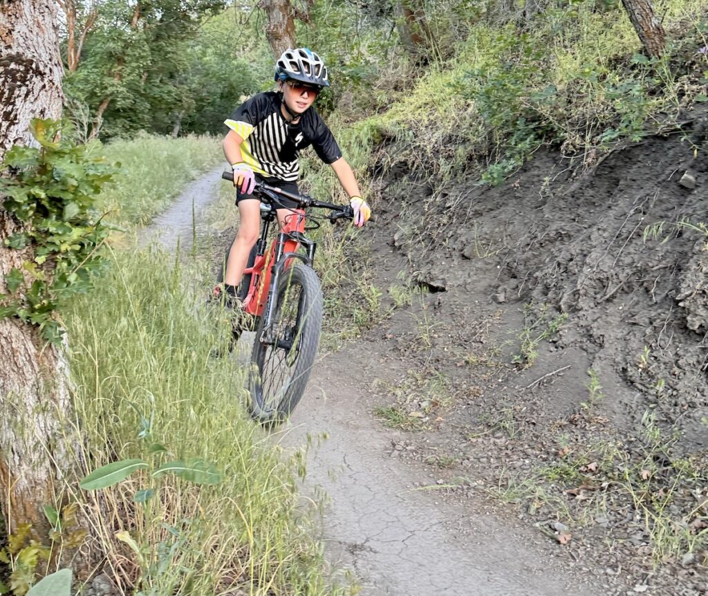 mountain biker cruising down a single track trail