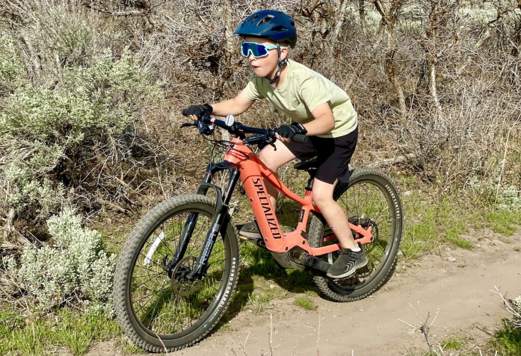 child riding the Specialized Turbo Levo SL Kids ebike