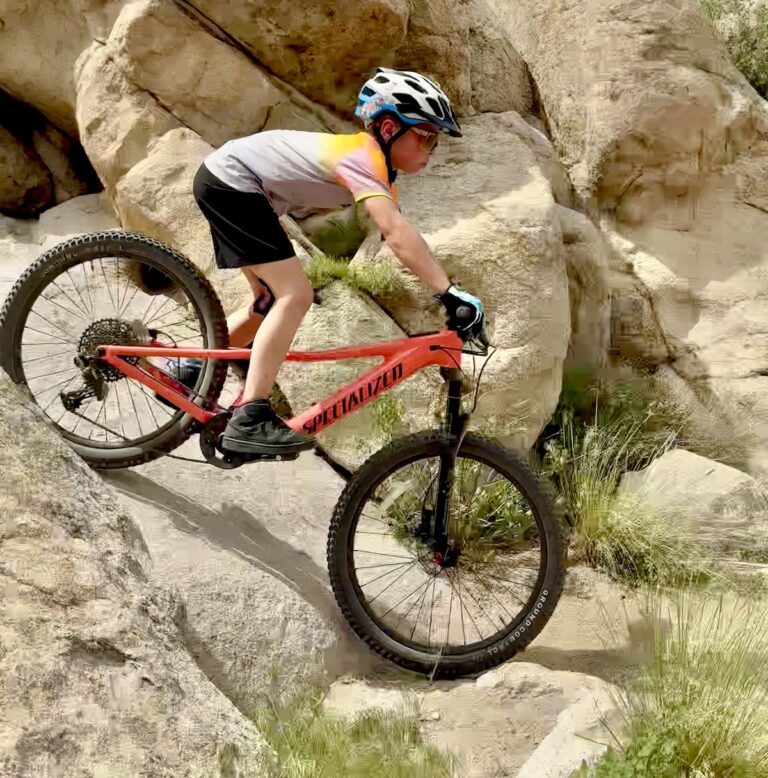 9 year old riding down slick rock on the Specialized 24" eMTB for kids