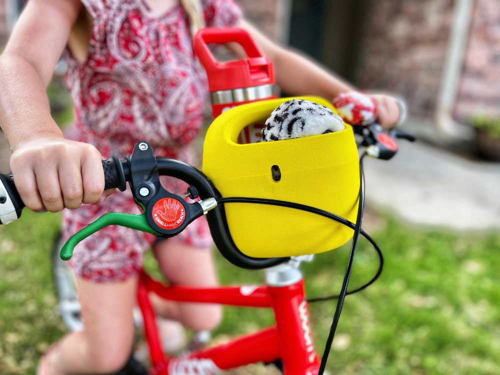 Yellow woom Pop bike basket on red woom 3 bike