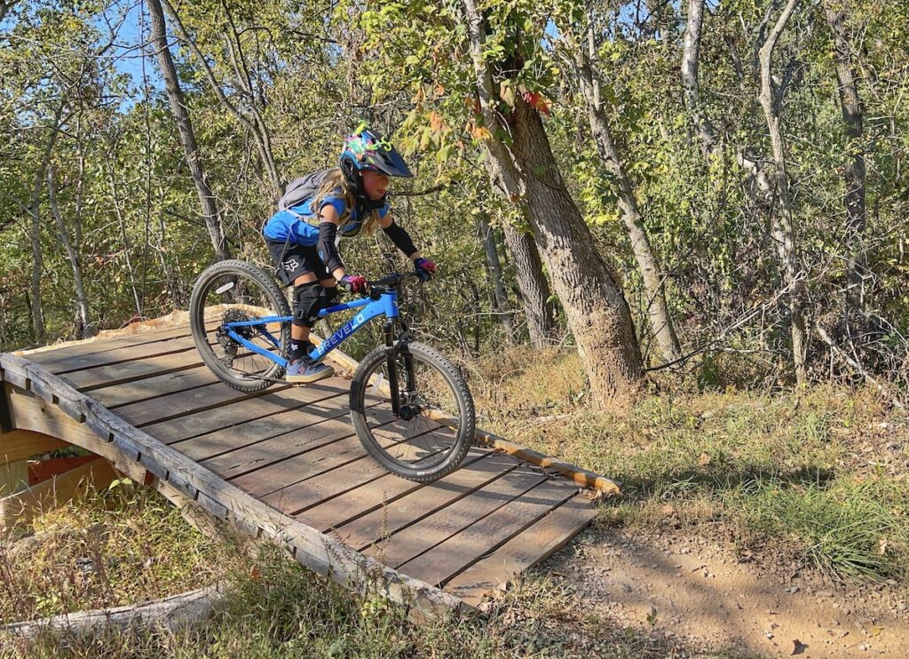 6 year old riding the prevelo zulu 24 inch mountain bike down a ramp
