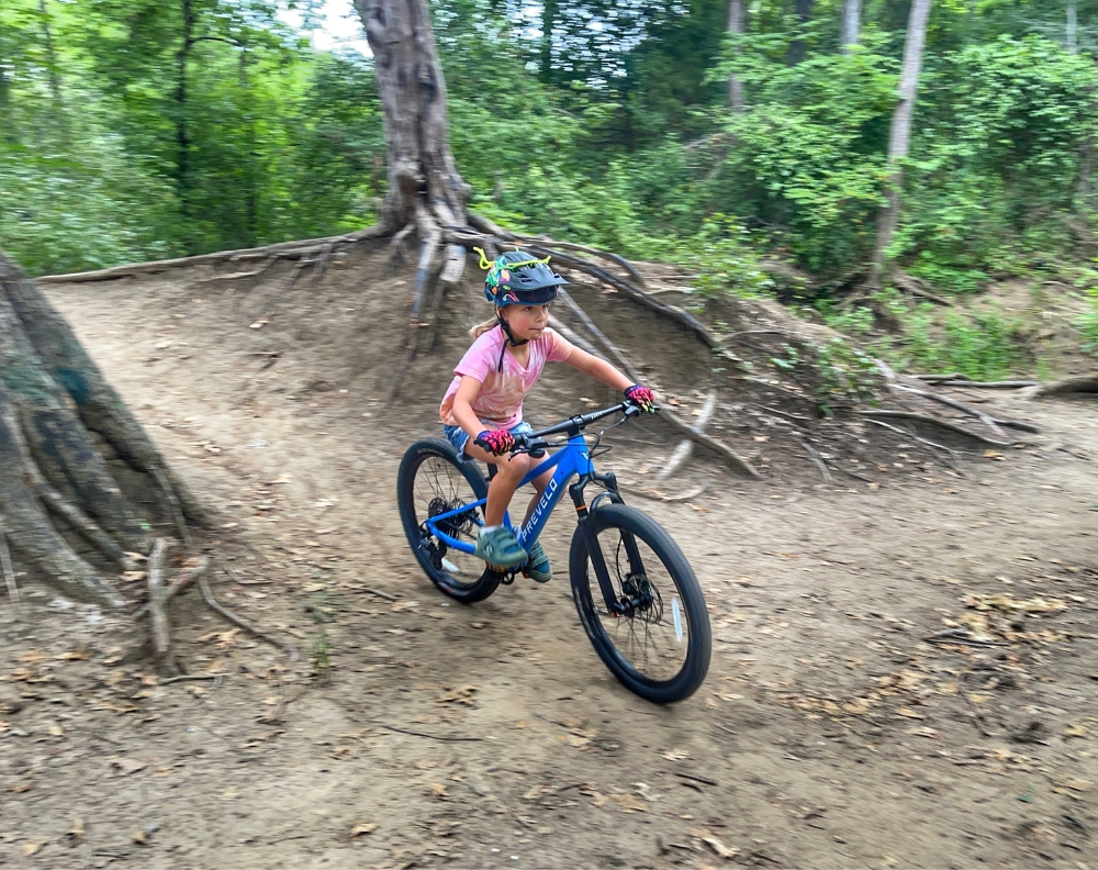 Young girl on mountain bike trail riding Prevelo Zulu Four
