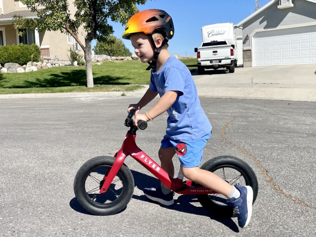 Child in 3t clothes riding the Rdio Flyer balance bike
