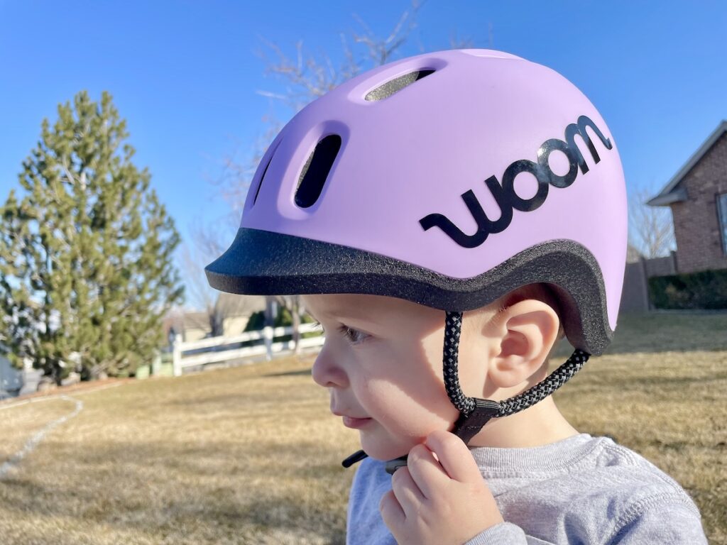 purple woom READY helmet on a toddler