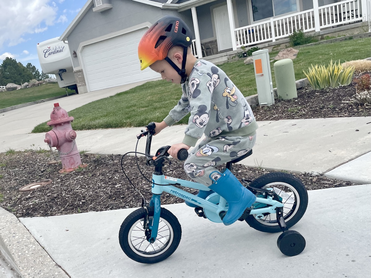 3 year old riding the Koda Plus 12 inch bike with training wheels