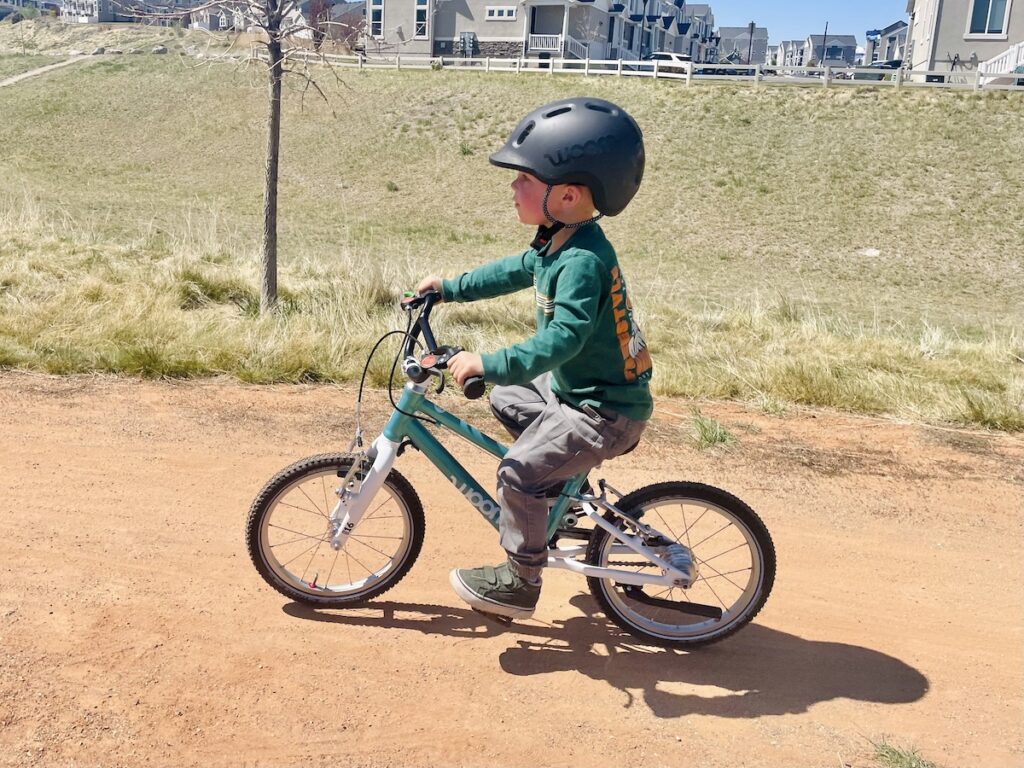 woom go 3 ridden on a compact dirt trail