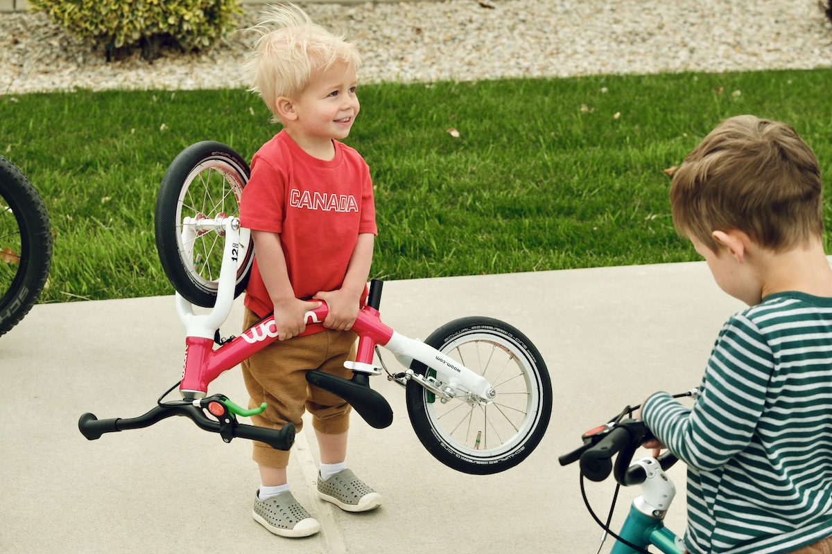 toddler lifting the woom go 1 balance bike