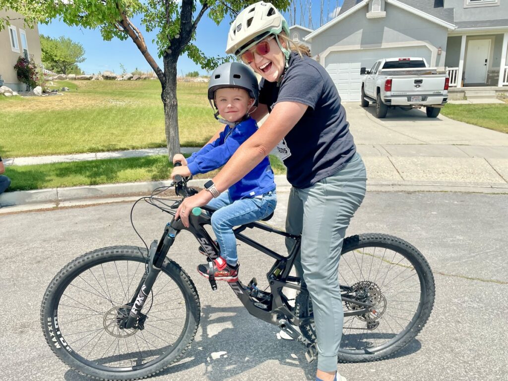 mom riding with tester on the shotgun pro bike seat