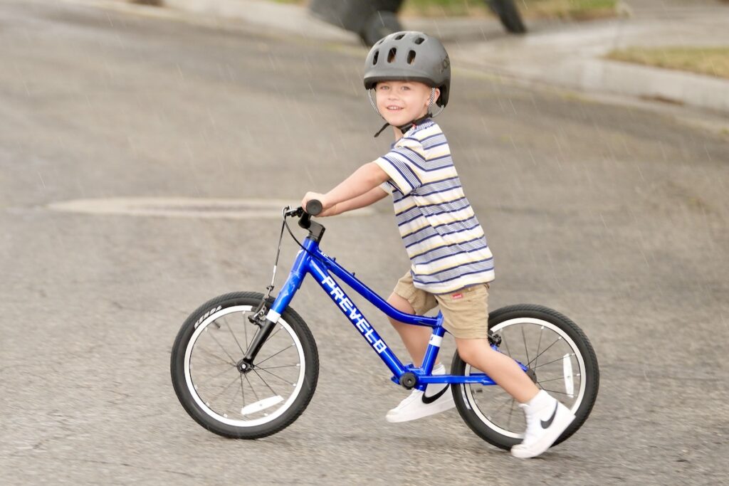 child riding the Prevelo Alpha Two as a balance bike