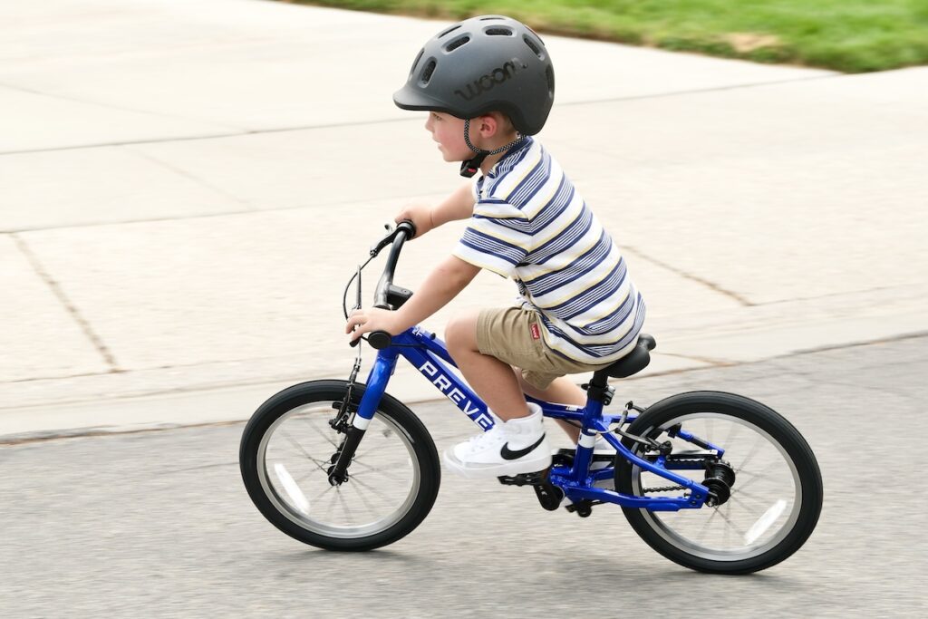 3 year old riding prevelo alpha two and leaning into a turn