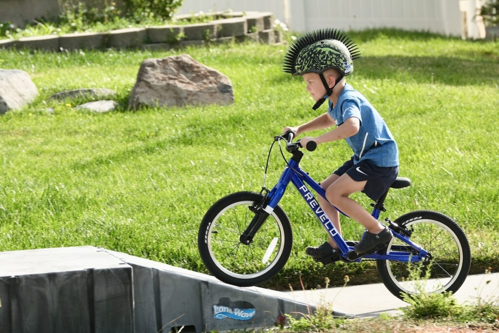 child rider going over a ramp on the Prevelo Alpha Two