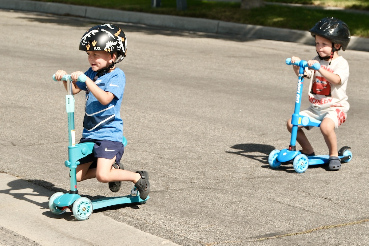 kids riding toddler scooter with seats