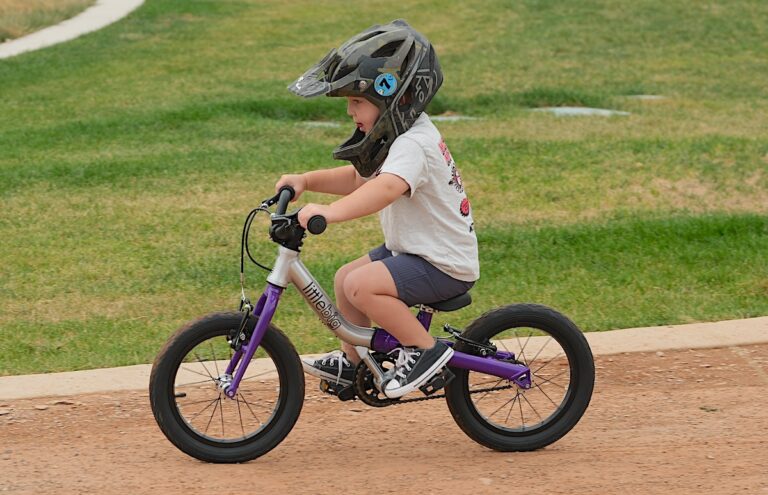 3 year old riding the little big convertible pedal bike