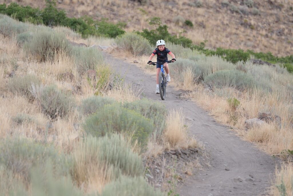 10 year old riding the prevelo alpha five up a hill