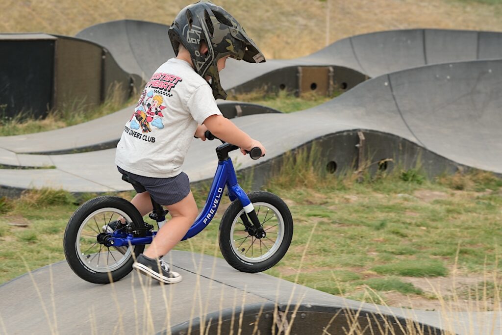 preschoolers riding the Prevelo balance bike down a ramp
