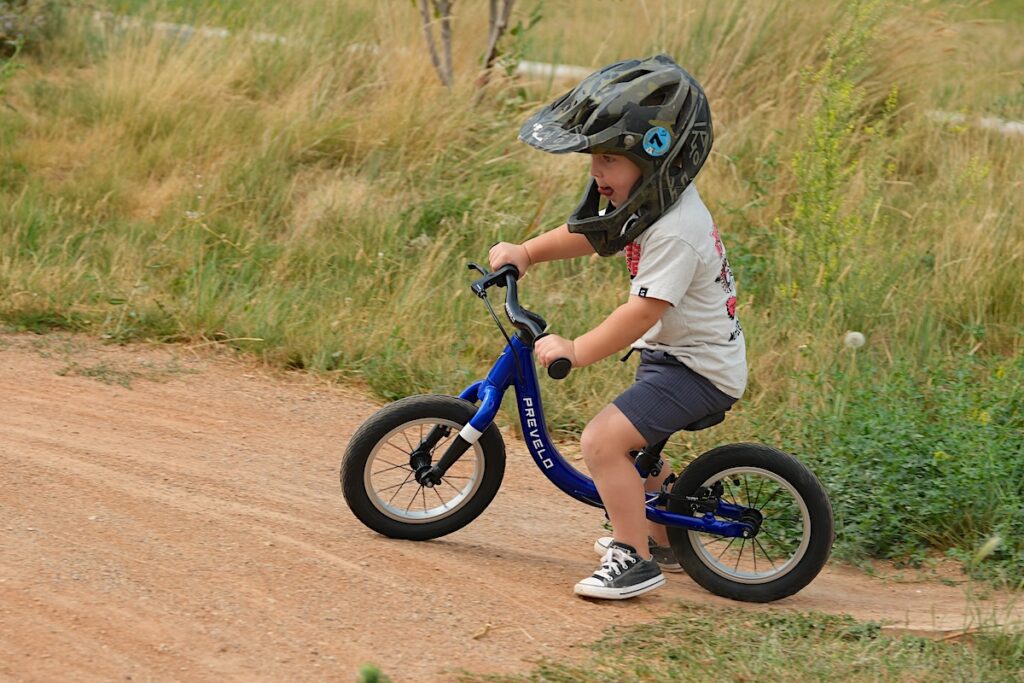 Prevelo balance bike being ridden on dirt