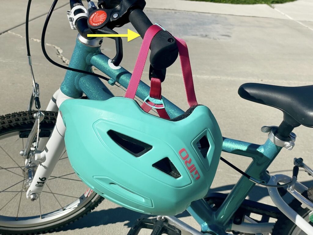 giro scamp hung by chin strap on handlebar